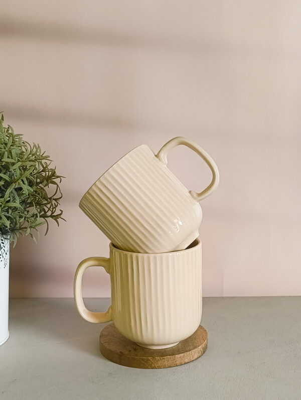 Handmade ceramic coffee mug in pastel beige