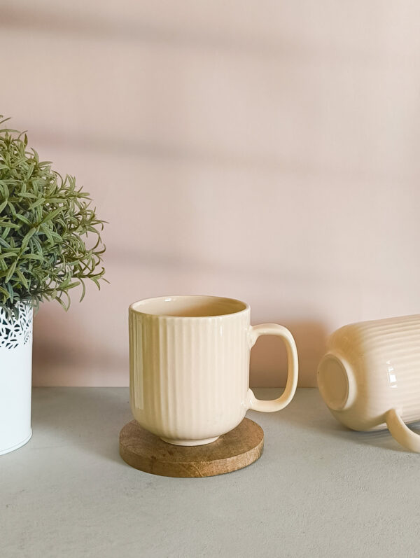 Handmade ceramic coffee mug in pastel beige