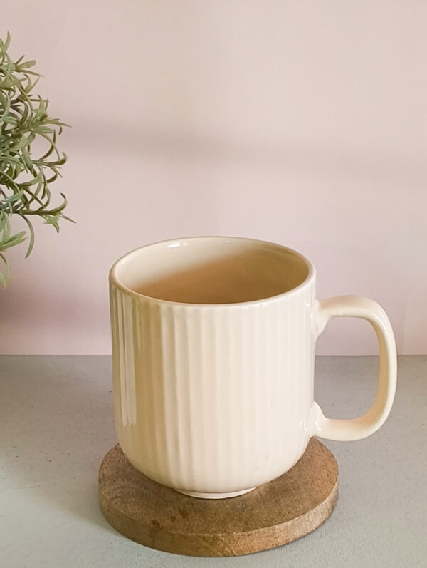 Handmade ceramic coffee mug in pastel beige