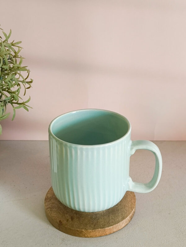 Handmade ceramic coffee mug in pastel green