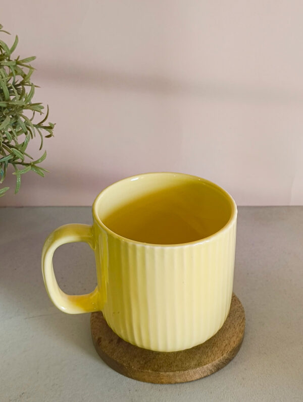 Handmade ceramic coffee mug in pastel yellow