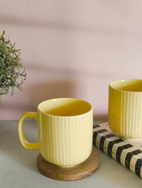 Handmade ceramic coffee mug in pastel yellow