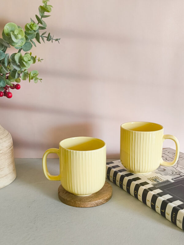 Handmade ceramic coffee mug in pastel yellow