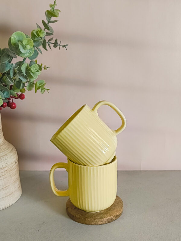 Handmade ceramic coffee mug in pastel yellow